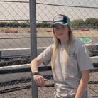 Chloe jones wearing the turquoise and black Retro Diamond trucker cap