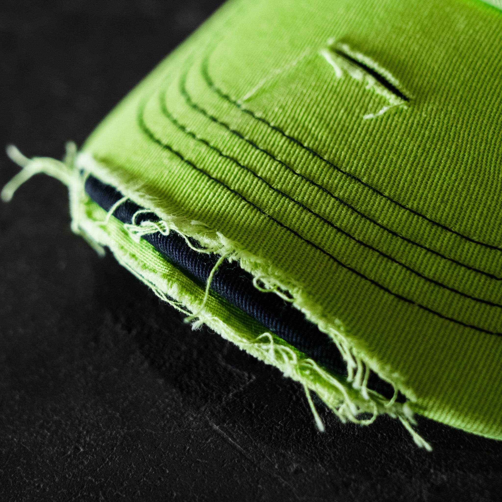 close up photo showing the peak of Kyle Ryde fluro limited edition trucker hat