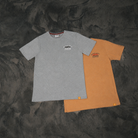Brown and grey Uggly & Co No Fuel Since ’95 T-shirts displayed side by side.