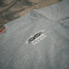 Close up of the No Fuel Since ’95 graphics on the grey Uggly & Co T-shirts.