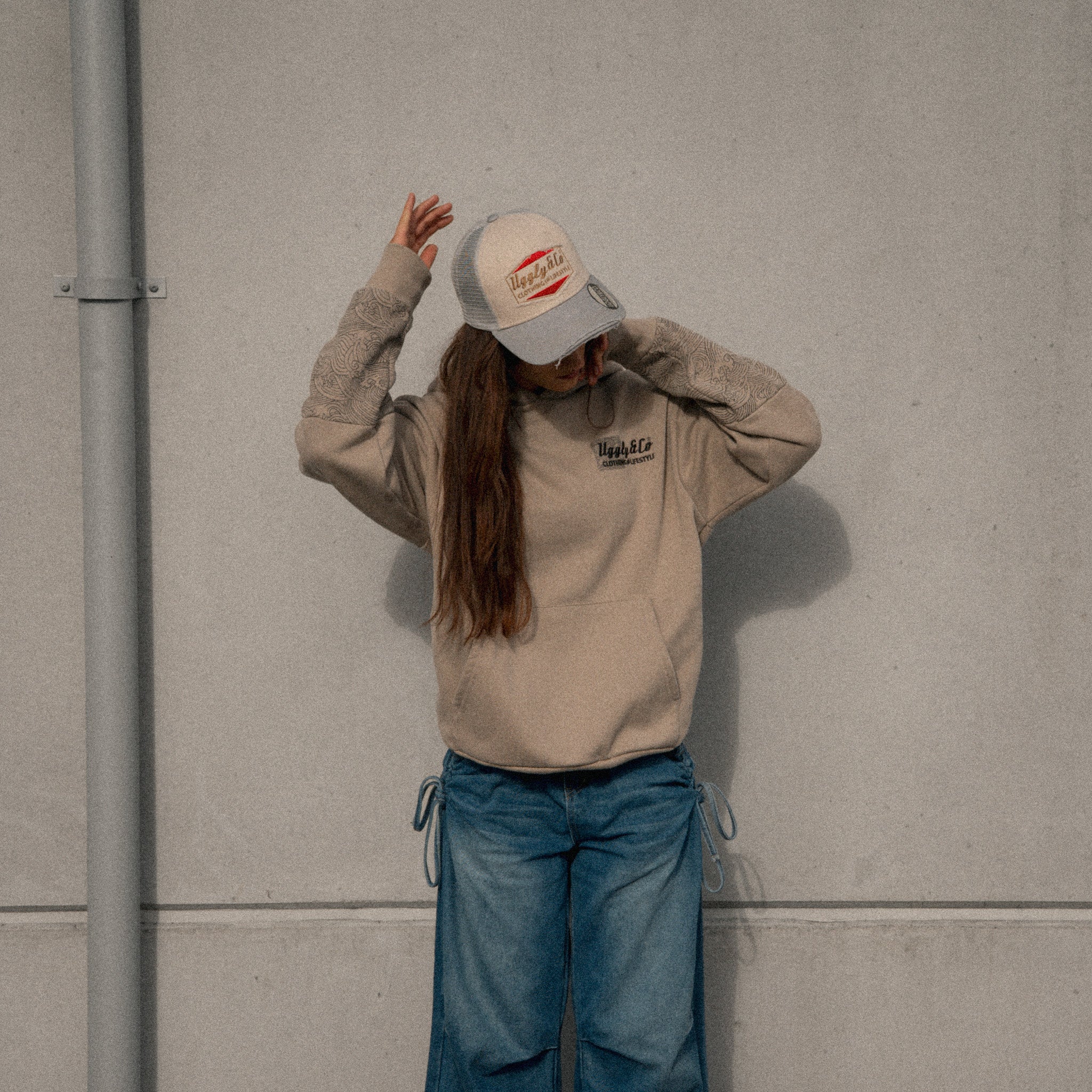 Female model wearing the Uggly & Co Silver & Grey Diamond Trucker Hat
