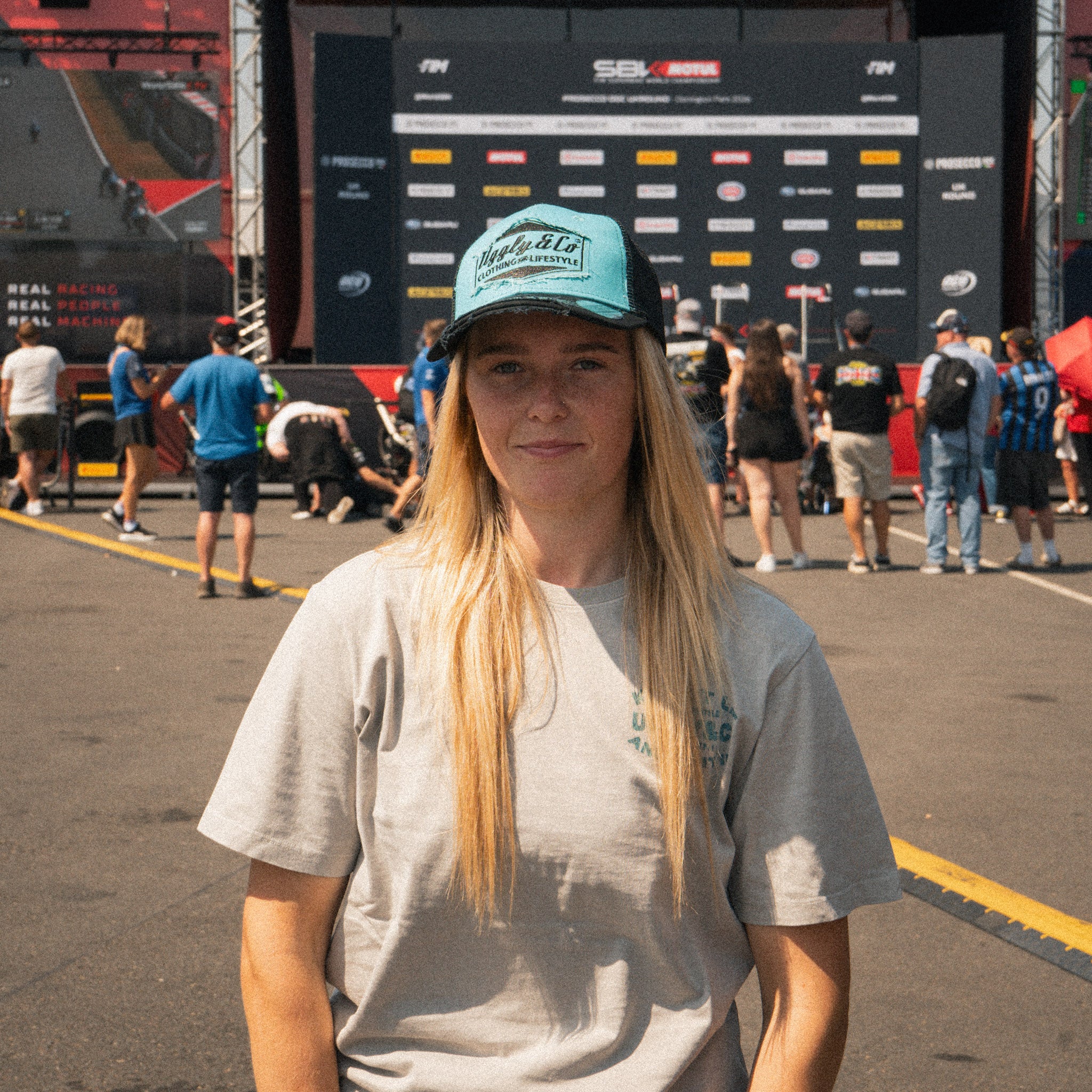 Chloe Jones in the Uggly&Co Turquoise and Black Diamond Cap during a race weekend