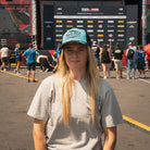 Chloe Jones in the Uggly&Co Turquoise and Black Diamond Cap during a race weekend
