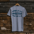 Rear view of the Keep it Lit Uggly&Co grey t-shirt on a wooden background