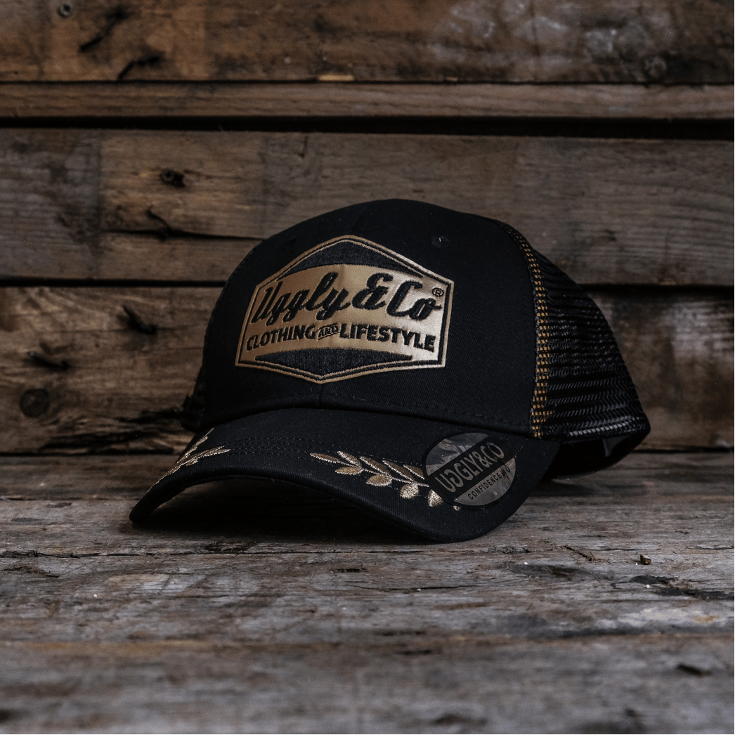 Black cap with a brand logo on a wooden surface