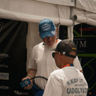 Mechanic wearing the vintage denim Diamond baseball cap in a race environment