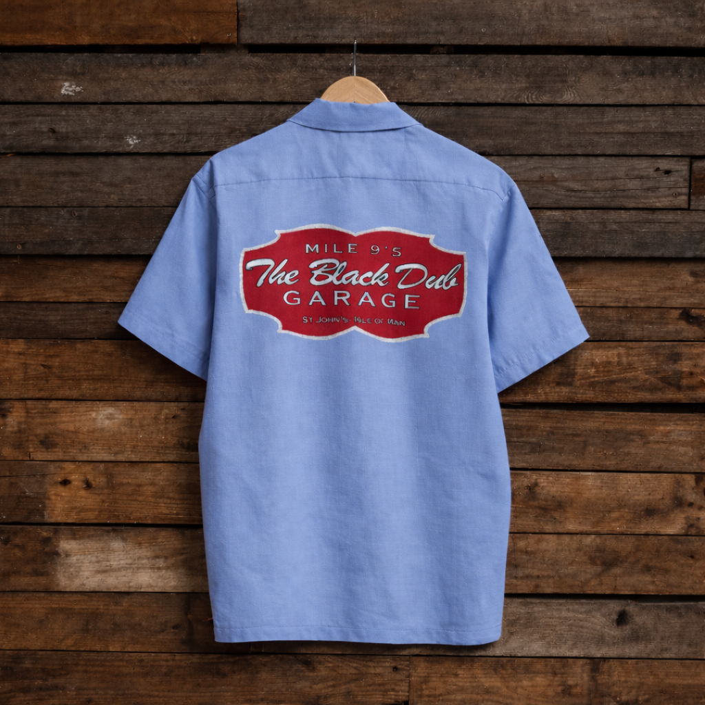 Blue work shirt with a red logo on a wooden background