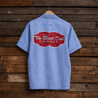 Blue work shirt with a red logo on a wooden background