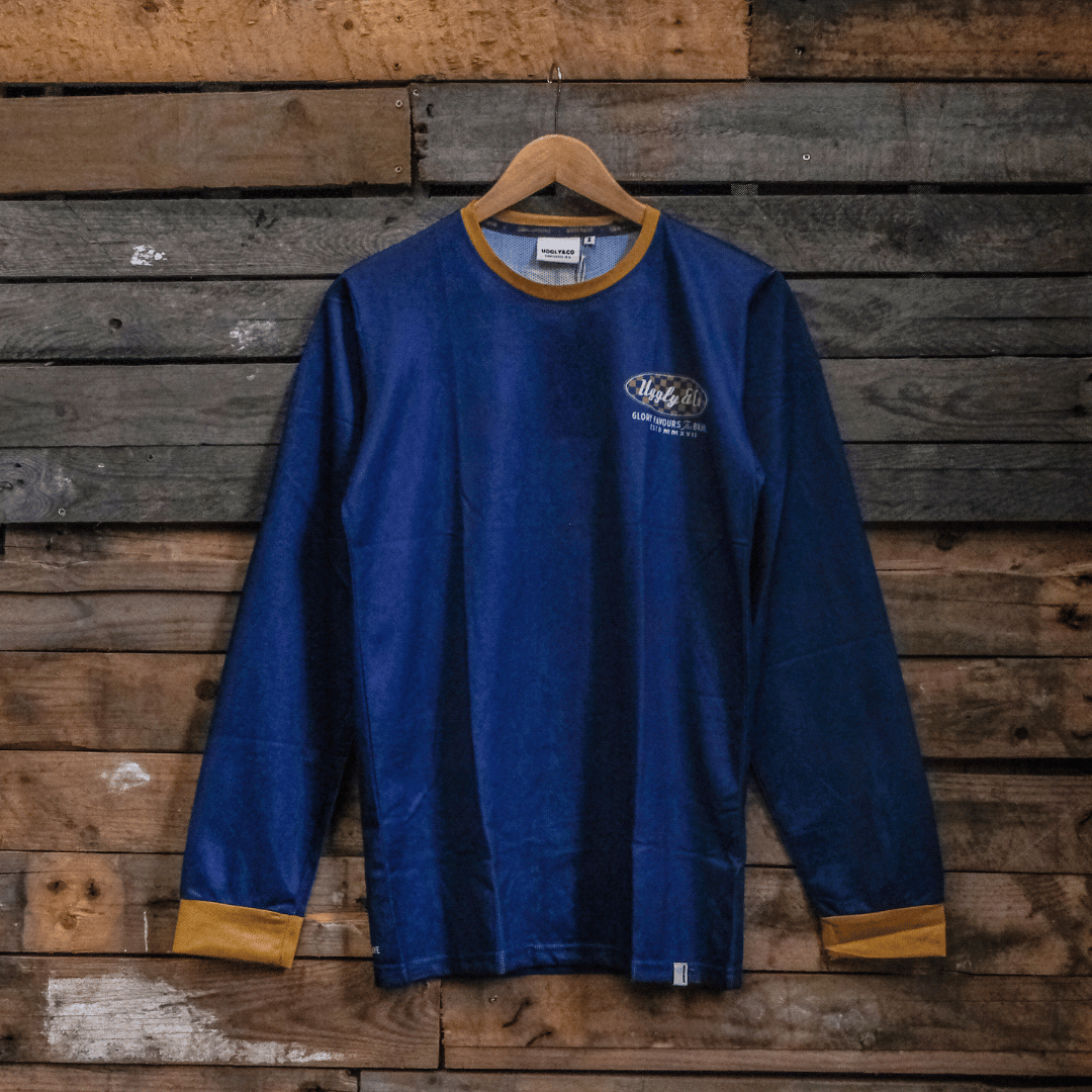 Blue MX shirt with an Uggly&Co logo on a wooden background