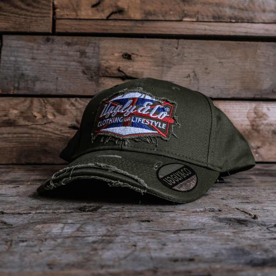 Green vintage cap with a union jack Uggly&Co brand logo on a wooden background