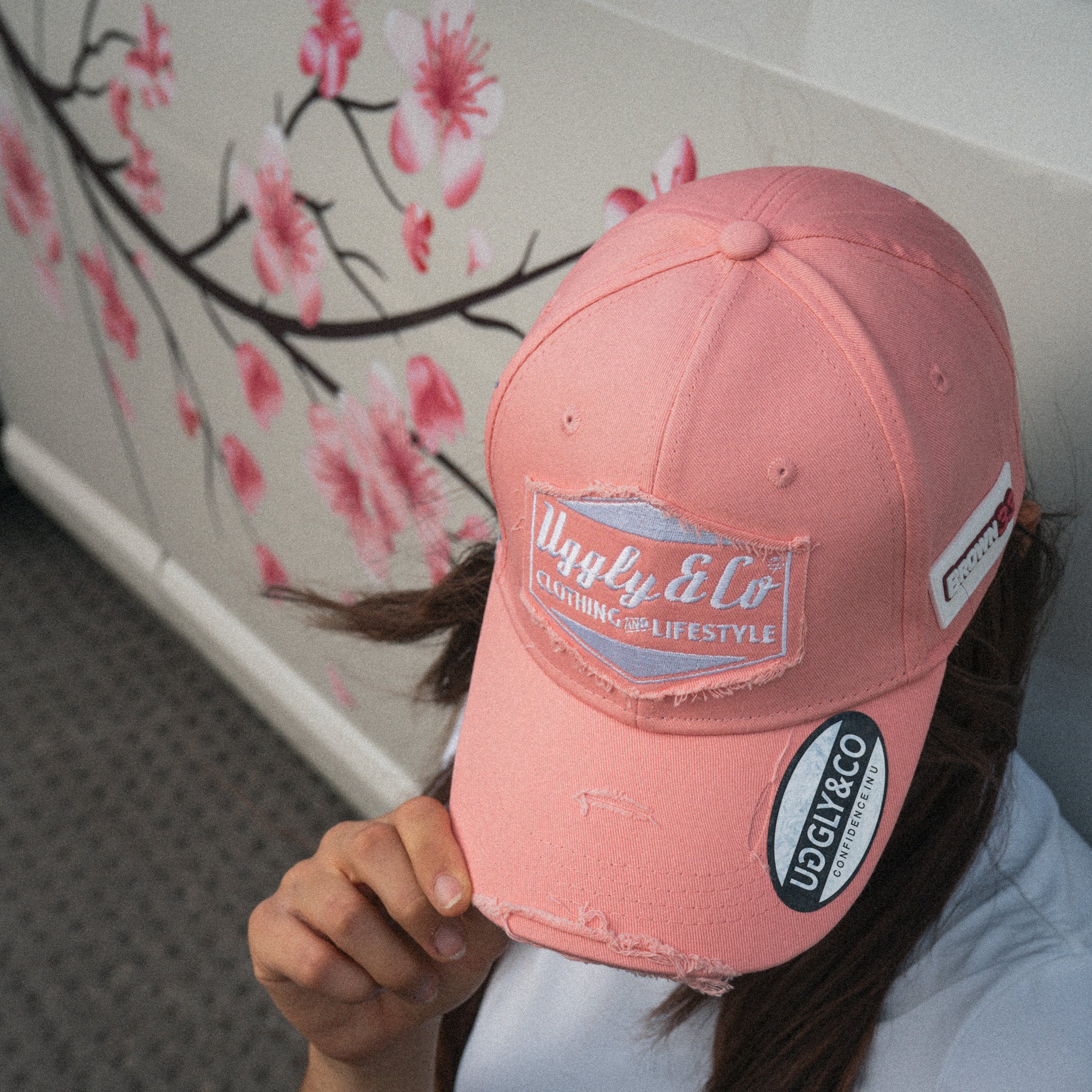 Automotive lifestyle photo of a female model wearing the Washed Pink Vintage Cap