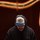 Wendigo wearing the Navy Blue & White Diamond Trucker Hat